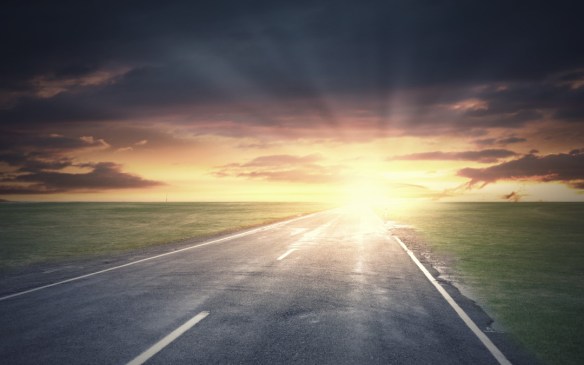 Sunrise above road